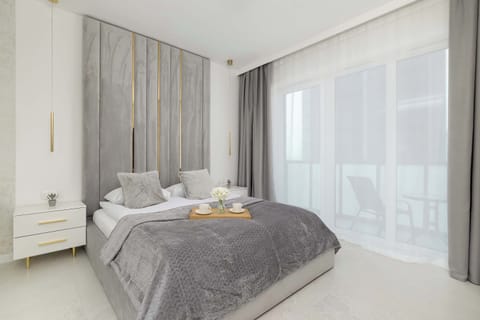 Relax in the stylish living area with a comfortable bed and modern decor.