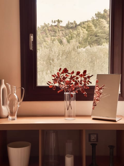 Interior corner of Bedroom 02 with natural light and understated furnishings
