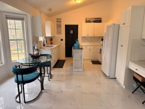 Kitchen, (microwave, air fryer)door leads to mudroom, laundry room, extra fridge