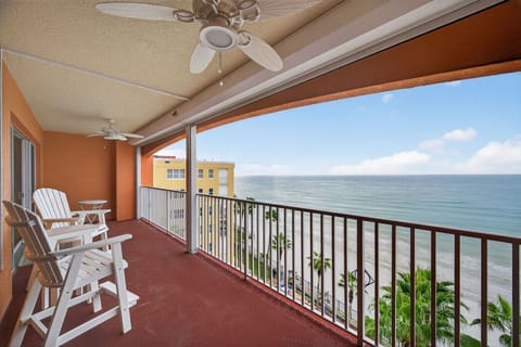 Covered oceanfront balcony w/ seating, perfect for breezy mornings overlooking the water.