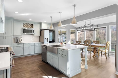 Bright, open-concept kitchen featuring a large island with seating for 3, modern appliances, and all the supplies you need to cook a meal for the family. Dining area includes seating for 6.