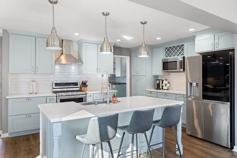 Bright, open-concept kitchen featuring a large island with seating for 3, modern appliances, and all the supplies you need to cook a meal for the family.