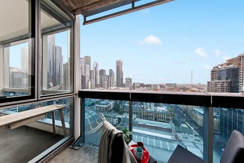 Enjoy city views from the balcony. *Chairs are from the dining area.