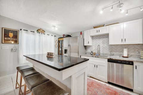 Modern kitchen with island seating and stainless appliances