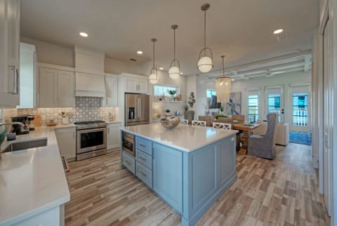 Kitchen features a large island and modern appliances.