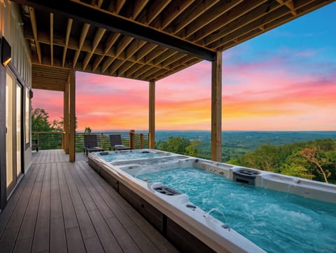 Soak beneath the covered deck as sunset colors the sky above sweeping mountain and valley views.