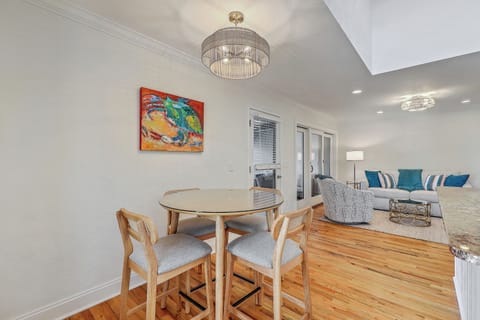 Our open-concept living area features a plush sofa, large TV, and breezy coastal vibes