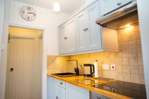 Wooden kitchen worktop with stainless steel hob and under-cabinet lights