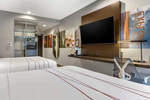 Stretch out with dual beds, big TV, and sleek storage.