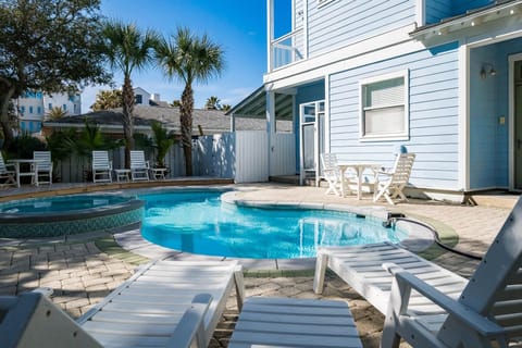 Your private pool paradise awaits with sparkling blue waters, comfortable loungers for soaking up the sunshine, and palm trees swaying overhead.