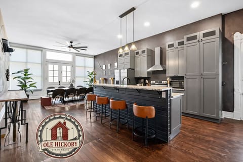 Our bright, open kitchen features original wood floors and a sleek breakfast bar