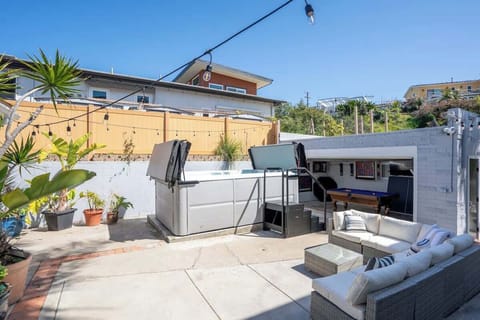 The patio lights up at night with string lighting overhead 