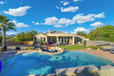 Resort-style pool with a curved design, clear water, and desert landscaping all around.