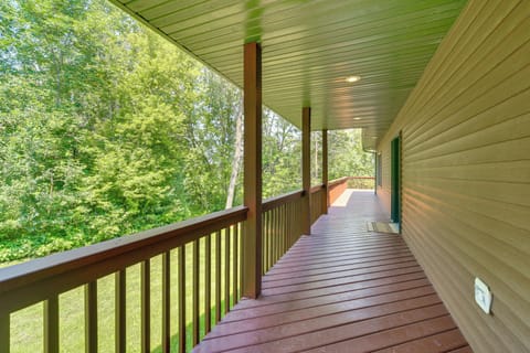 Porch leading to the front door that wraps around the lake side