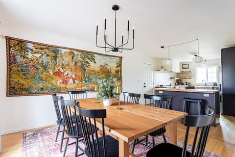 Handcrafted wood table, modern lighting, and artful details flow seamlessly into the open kitchen