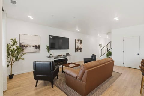 Spacious living room featuring comfortable seating, Smart TV, and open layout.