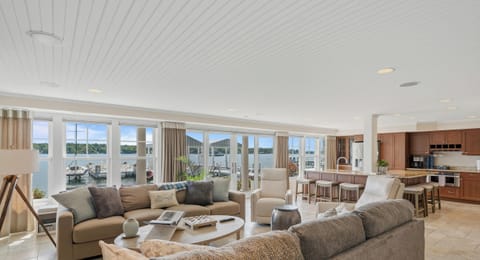 Main level open concept living room and kitchen. Opens to patio and pier.