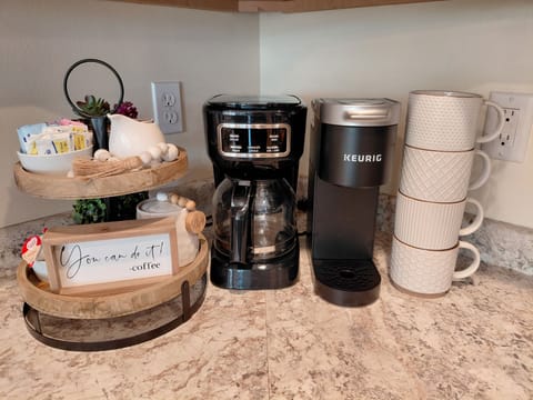 Two coffee makers, coffee grounds/k-cups, mugs and all the fixings included