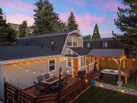 Sunset view of the back of the property and hot tub cover.