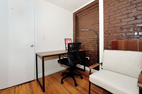Your dedicated workspace features exposed brick walls and modern furnishings, creating an inspiring atmosphere for productivity.