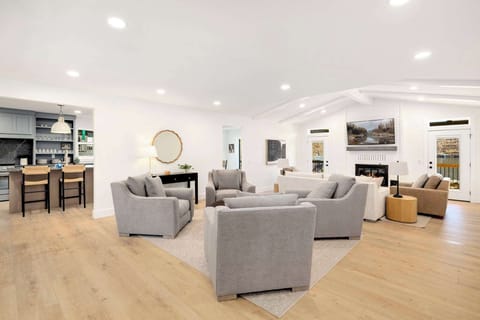 Spacious living room with cozy seating, Smart TV, fireplace, and lake views!