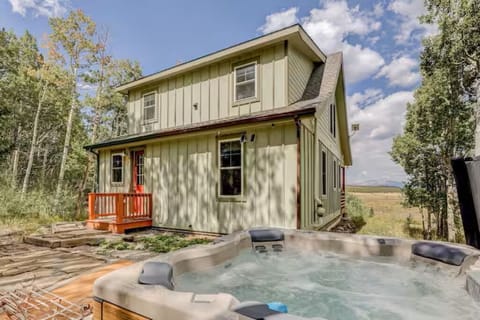 Sit back and relax in the private hot tub with gorgeous mountain views
