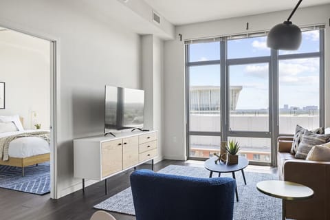 Lounge by oversized windows with coffee and city light.