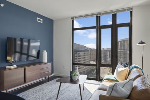 Unwind on the leather sofa with bright skyline views.