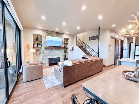 2) Spacious living room with stone fireplace and mountain views