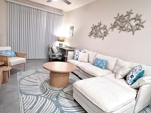 Living area leads out to patio with 2 chairs.