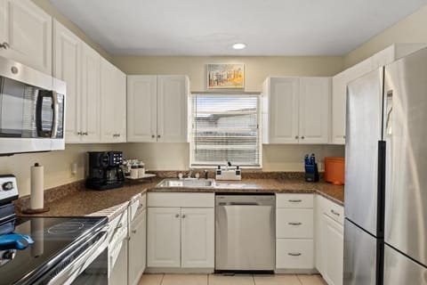 Fully equipped kitchen with stainless appliances and ample counter space
