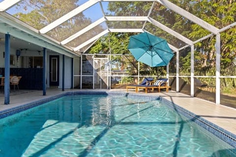 Screened-in private pool with canal views and all-day Florida sunshine