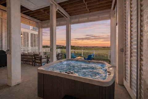 Private covered hot tub with sunset views, perfect for relaxing after a day on the beach.