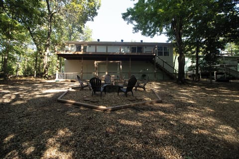 Cozy outdoor seating area with Adirondack chairs arranged around a fire pit