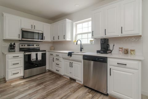Pristine white cabinetry and sleek stainless steel appliances