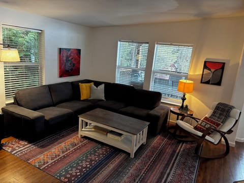 Spacious living room with sectional couch, rocking chair, 55” Roku TV 