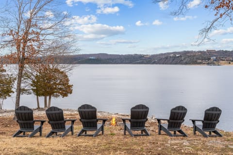Relax lakeside in Adirondack chairs just steps from the water at this Table Rock Lake retreat.