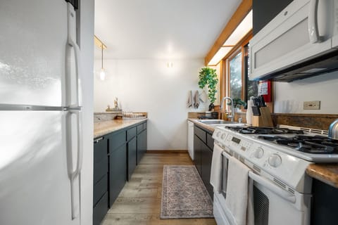 A galley style kitchen maximizes the space and features a gas stove
