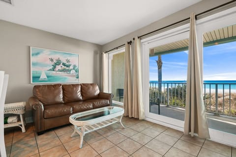 Relax in this cozy living room with ocean views through large sliding glass doors.