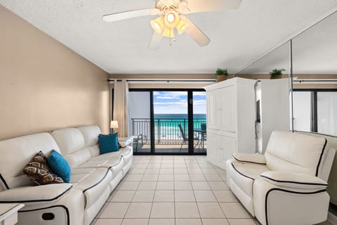 Relax in this bright living room with ocean views and direct balcony access.