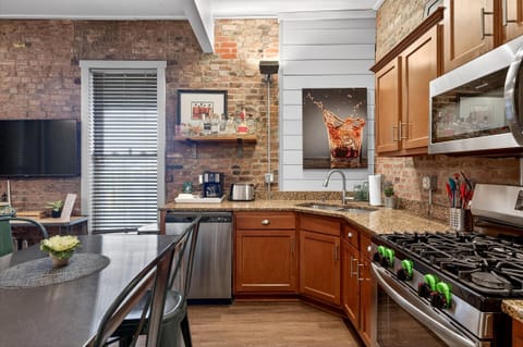 Our kitchen is fully stocked with stainless steel appliances and a gas range for gourmet meals. The wooden cabinetry provides ample storage for all your grocery needs.
