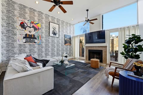 Sunlit open-plan living area w/ sleek finishes and art perfect for unwinding