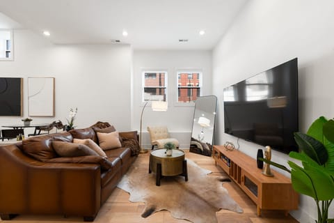 Inviting living room framed by bright walls & comfy sofas.