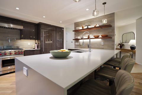 Chef’s kitchen with Wolf & Sub-Zero, waterfall island seating four.