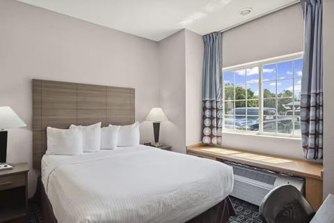 Wake up to natural light beside a wide, comfy bed.
