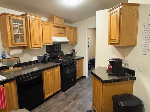 Well stocked kitchen with dinnerware, silverware, bakeware, glasses, etc.