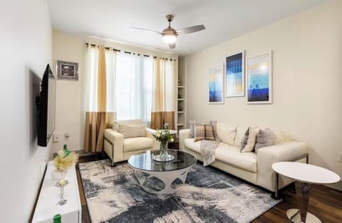 Cozy modern lounge with plush seating & glass coffee table