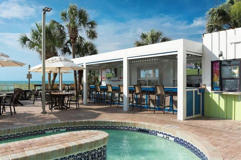 Linger with friends at the airy beachfront bar and seating.