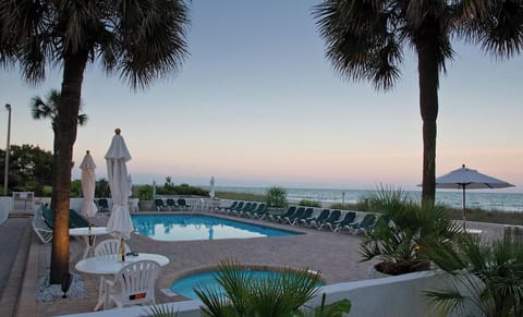 Sip evening drinks as sunset colors glow over the pool.