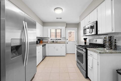 Full kitchen with appliances and cooking essentials